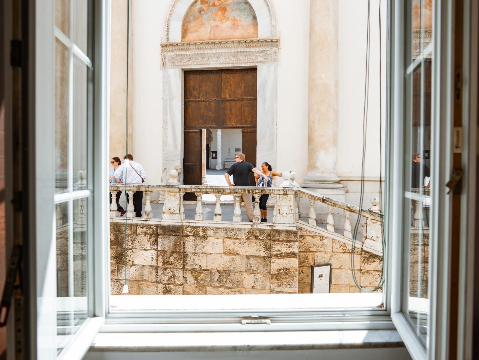 Through the open window in Gea, the cathedral doorway and the atrium balustrade