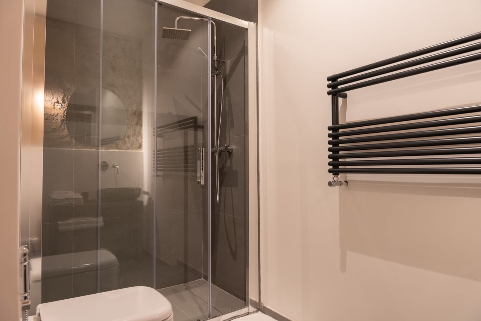 The glass shower in Hera, next to the towel warmer