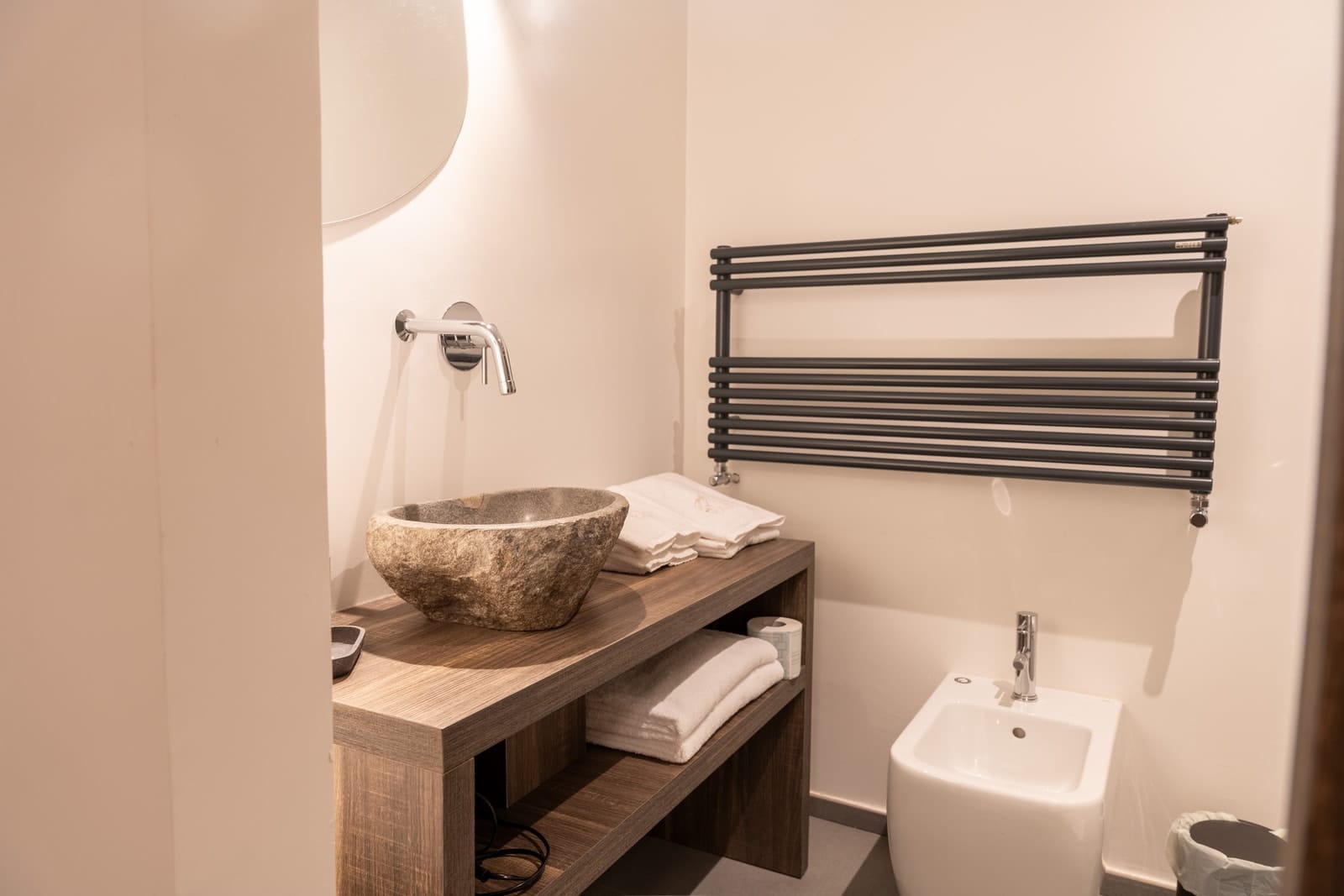 The bathroom in Hestia: the stone basin, the bidet and the towel warmer